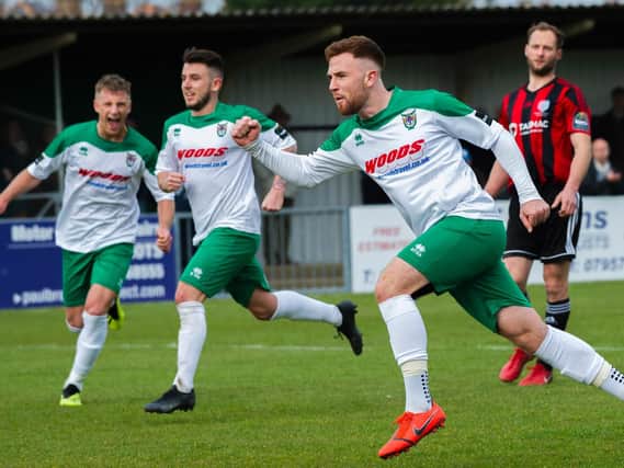 Theo Widdrington takes the plaudits after pulling Bognor level from the spot / Picture by Tommy McMillan