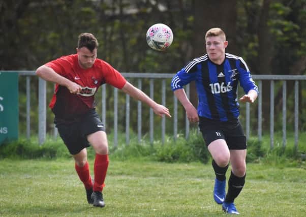 Hollington United and Cuckfield Rangers compete for a bouncing ball