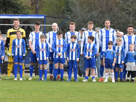 Haywards Heath Town's team and mascots line-up before kick-off.
Picture by Grahame Lehkyj