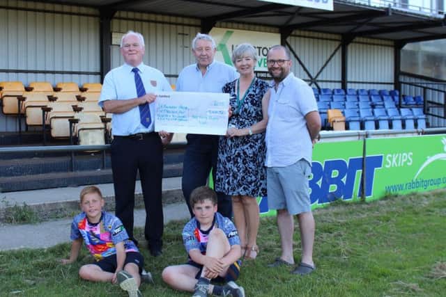 Worthing Rugby Club presents the £5,410 cheque to St Barnabas House following last year's inaugural firewalk