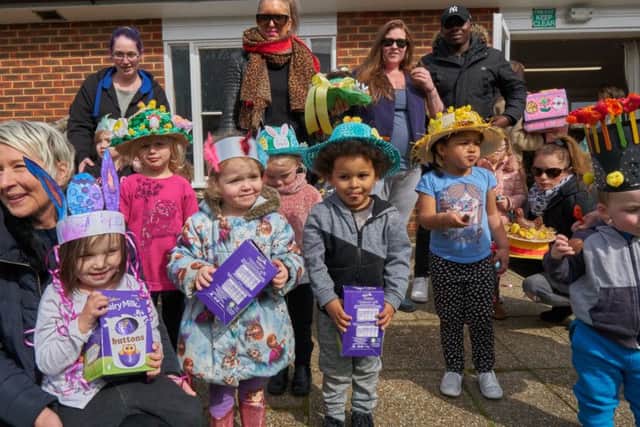 The three winners of the Easter bonnet competition with their Easter egg prizes and others taking part