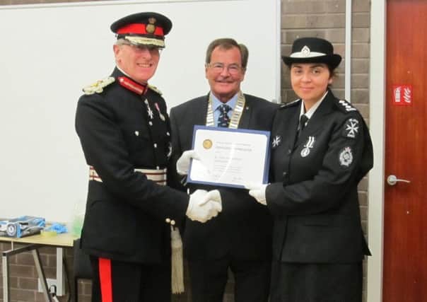 Lord Lieutenant Peter Field with rotary club president David Garlick presenting the certificate to Saricka March, member in charge of the Eastbourne unit of St John Ambulance. SUS-191004-103338001