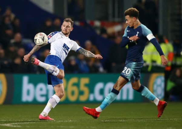 BIRKENHEAD, ENGLAND - JANUARY 04:  James Norwood of Tranmere Rovers in action while under pressure from Dele Alli of Tottenham Hotspur during the FA Cup Third Round match between Tranmere Rovers and Tottenham Hotspur at Prenton Park on January 4, 2019 in Birkenhead, United Kingdom.  (Photo by Jan Kruger/Getty Images) SUS-190804-172940002