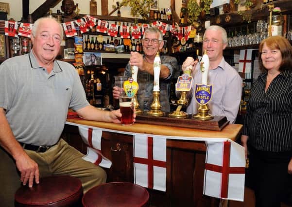 Queens Head Pub, Icklesham. Beer Festival.
02.10.10.
Picture by: TONY COOMBES PHOTOGRAPHY.
Customer David Martyn with bar staff Rob May, Ian Mitchell and Sally Warren.
BH41702b
