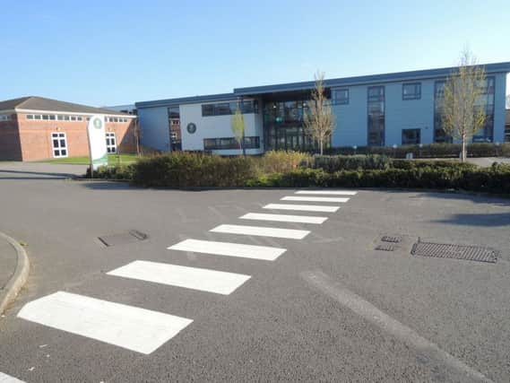 The crossing at Millais School in Horsham ... which leads into a hedge SUS-191204-123143001