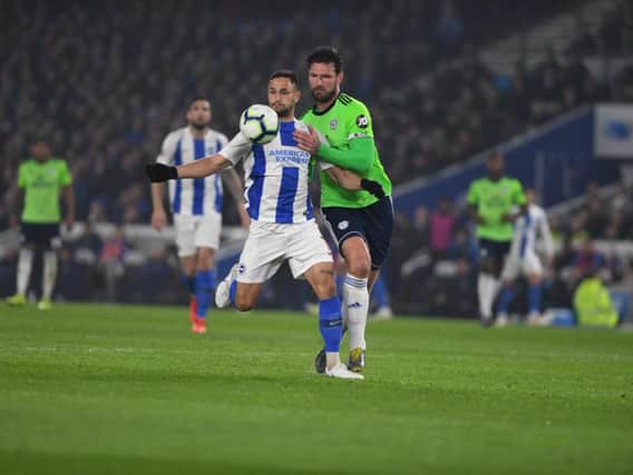 Florin Andone (left) and Sean Morrison battle for the ball in tonight's game between Brighton & Hove Albion and Cardiff City. Picture by PW Sporting Photography.