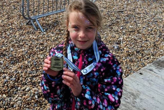 Daisy Akehurst, seven, completed the Cancer Research UK Mini Mile, her first race on her own