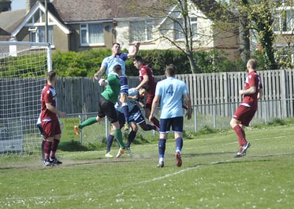 Little Common defend a cross into their penalty area against AFC Uckfield Town