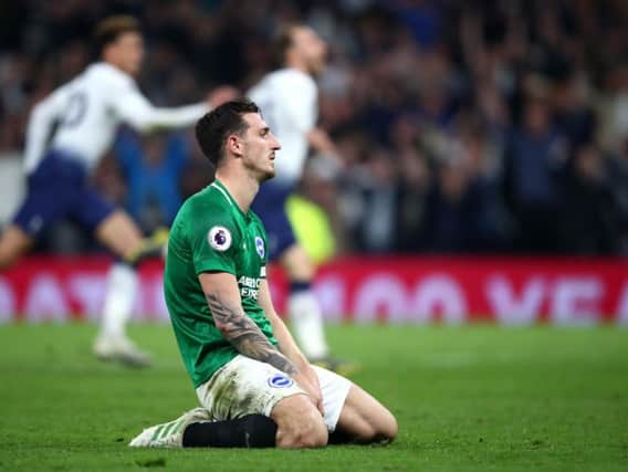 Lewis Dunk on his knees after Tottenham's late winner. Picture by Getty Images