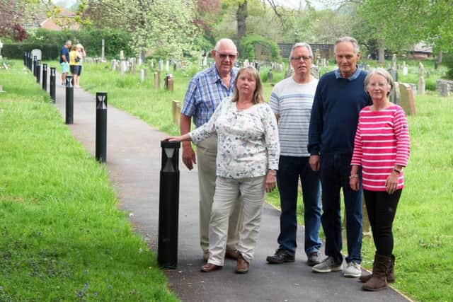 Henfield residents are annoyed at 'floodlighting' that has been installed in the cemetery near their homed. Pictured from left, Gordon Barr, Sarah Terry, John Rodriguez, Chris Carr and Linda Gale. Photo by Derek Martin Photography. SUS-190423-174838008