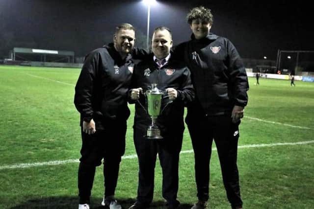 AFC Gatwick manager Rob Corcoran, middle, lifts the Tony Kopp Cup