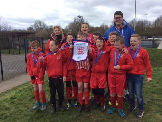 English Martyrs Catholic Primary School celebrate their triumph at the Danone U11 Regional Small Schools Football Finals in March.