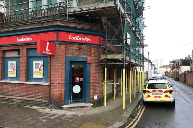 Police at the scene of the robbery in Worthing yesterday (April 24)