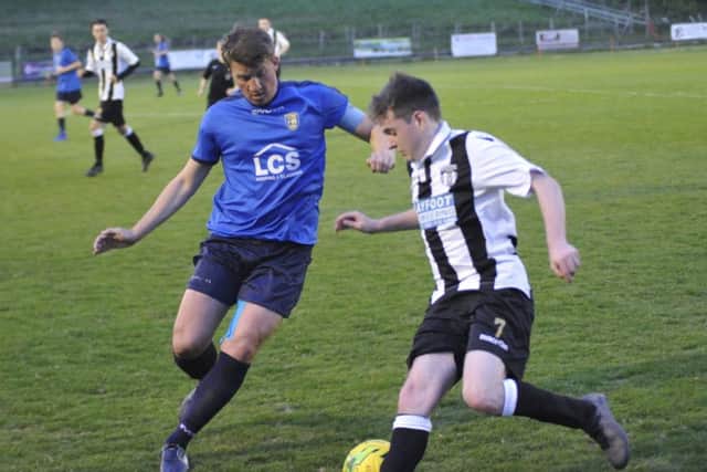 Action from the Hastings & District FA Intermediate Cup final between Sedlescombe Rangers (blue kit - Dom Bristow) and Robertsbridge United (white and black kit)