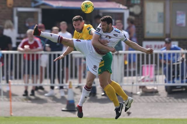 Hastings United defender Gary Elphick in the thick of the action during Easter Monday's 2-2 draw at home to Ashford United. Picture courtesy Scott White