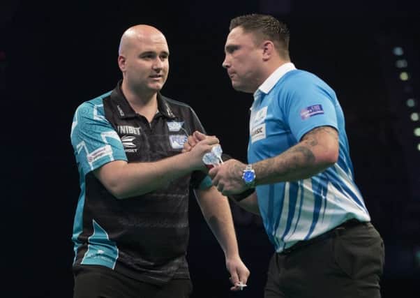 Rob Cross (left) shakes hands with Gerwyn Price after their 7-7 draw. Picture courtesy Lawrence Lustig/PDC