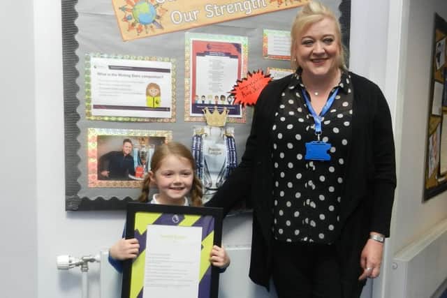 Ava Yeates with teacher Alison Pernet, who runs the literacy group