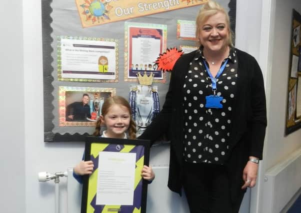 Ava Yeates with teacher Alison Pernet, who runs the literacy group
