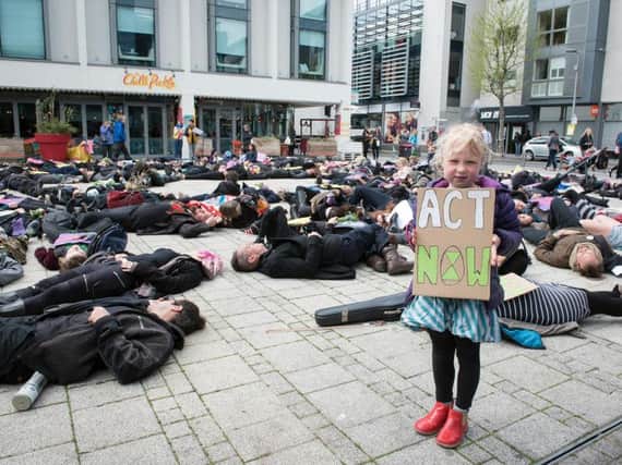 A die-in held at Jubilee Square, Brighton, by Extinction Rebellion activists