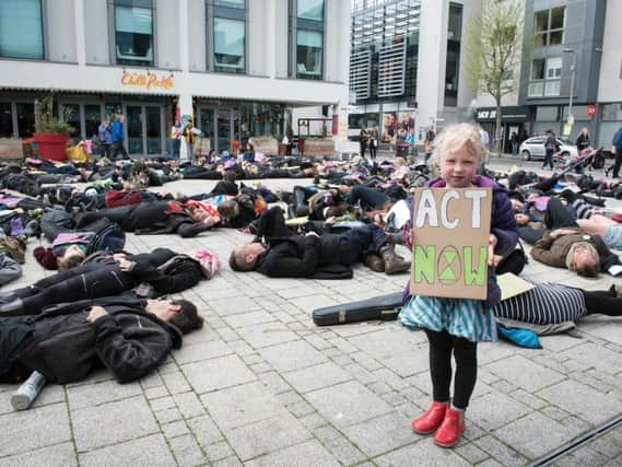A die-in held at Jubilee Square, Brighton, by Extinction Rebellion activists (Credit: Danny Fitzpatrick)