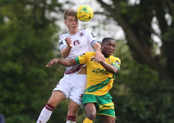 Hastings United defender Jack Tucker wins a header during Easter Monday's league game at home to Ashford United. Picture courtesy Scott White