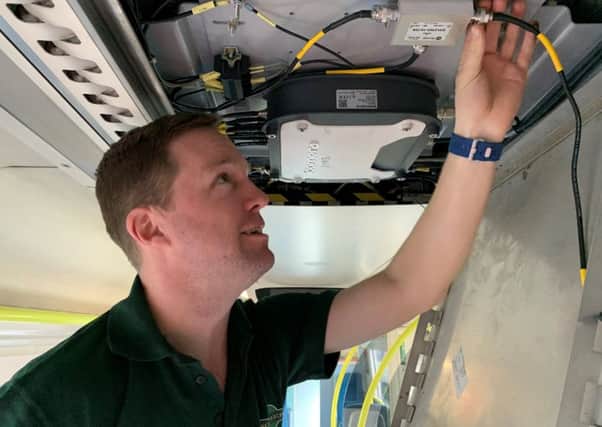 GTR Wireless Systems Engineer Robin Hayman inspects Wi-Fi fitted to the final Southern units