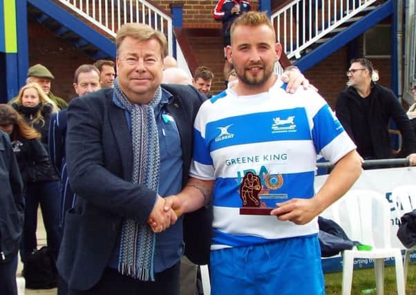 Hastings & Bexhill Rugby Club captain Joe Umpleby receives the Bob Rogers Sussex Cup runners-up trophy from Simon Dixon, south coast area manager of Harvey's Brewery. Picture courtesy Peter Knight