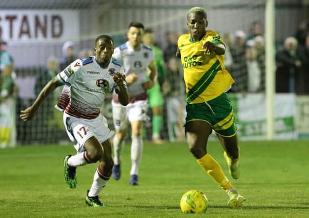 Lanre Azeez competes for the ball with Ashford United full-back Laurent Mendy. Picture courtesy Scott White