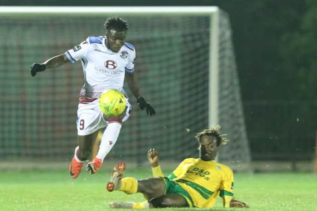Daniel Ajakaiye skips away from Ashford United wide player Toby Ajala. Picture courtesy Scott White
