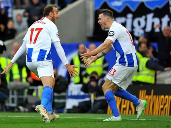 Pascal Gross and Glenn Murray celebrate the equaliser against Newcastle on Saturday. Picture by Steve Robards