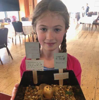 Grace Samuels, ten, with her winning entry to the egg decorating competition