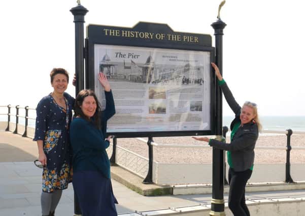 Nadia Chalk and Vanessa Breen (both Creative Waves) and Judy Fox (Discover Worthing) as Worthing's seafront signs are upgraded
