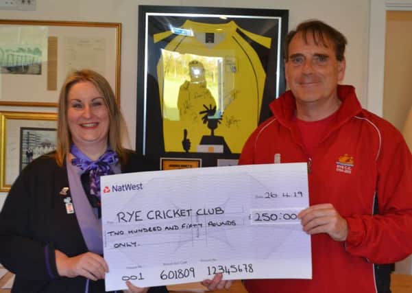Clare Lands, of NatWest, presents a cheque for £250 to Rye Cricket Club's Martin Blincow following the club's involvement in the recent NatWest CricketForce event