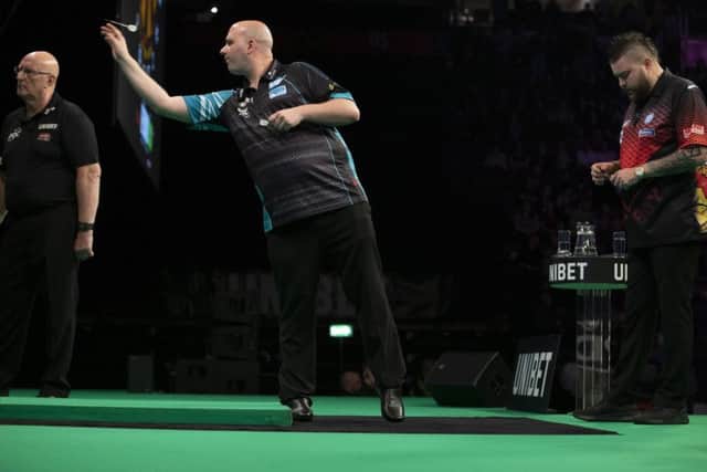 Rob Cross at the oche against Michael Smith. Picture courtesy Lawrence Lustig/PDC