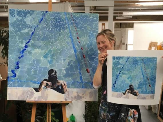 Artist Emily Stevens with a her painting Contemplating, which she created at Pells Pool last summer