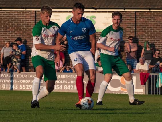 Dan Smith - who later joined the Rocks on loan - holds off Tommy Block, watched by Keaton Wood, in last year's Rocks-Pompey game / Picture by Tommy McMillan