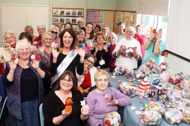 Littlehampton knitters present more than 5,000 little hats to Age UK for The Big Knit with innocent. Photo by Derek Martin DM1951033a