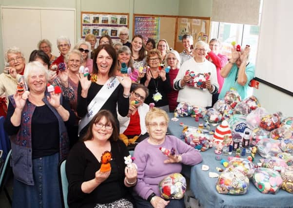 Littlehampton knitters present more than 5,000 little hats to Age UK for The Big Knit with innocent. Photo by Derek Martin DM1951033a