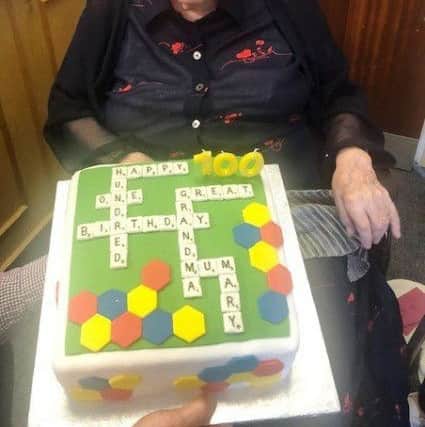 Mary Dench with her Scrabble themed birthday cake. Picture: Amy Holder