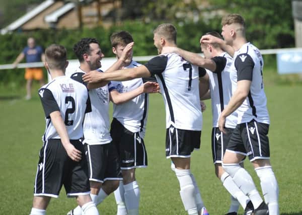 Bexhill United celebrate scoring during their Easter Monday victory away to Hailsham Town