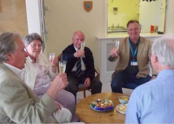 Residents at RAFA Storrington raising a toast to the independent living scheme which started 40 years ago SUS-190805-122414001