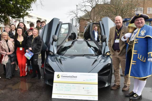 The McLaren 720S coupe at the first workshop, when Worthing Community Chest chairman Karl Allison with Worthing town crier Bob Smytherman, right, presented a cheque for £1,500 to Talent Within You. Picture: Kate Henwood Photography