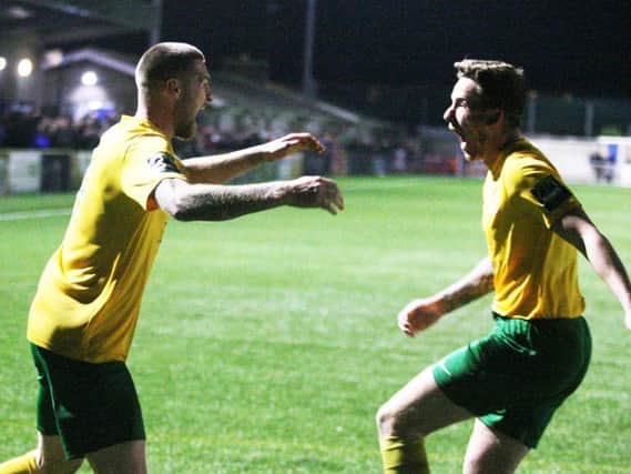 Dylan Merchant (left) celebrates his match-winning goal to seal Horsham's promotion. Picture by Derek Martin Photography