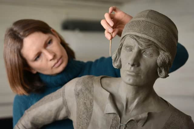 Sculptor Hannah Stewart with her bronze of pioneering footballer Lily Parr SUS-191005-151816001