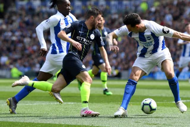 Manchester City's Bernardo Silva kinks past Brighton's Lewis Dunk and Bernardo. Picture by Getty Images.