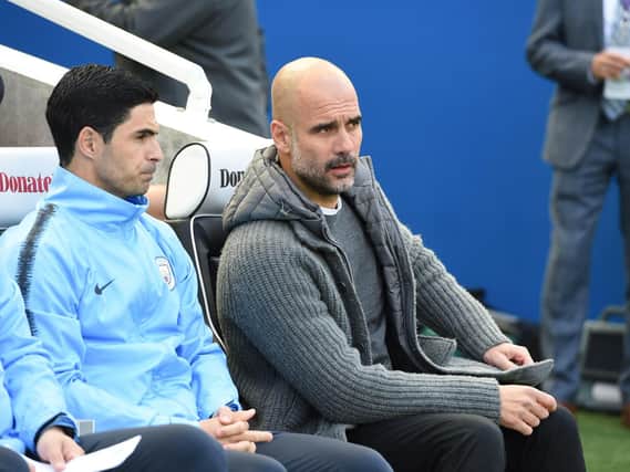 Manchester City boss Pep Guardiola (right) and assistant Mikel Arteta. Picture by PW Sporting Photography