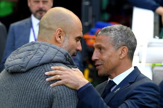 Josep Guardiola, Manager of Manchester City is greeted by Chris Hughton, Manager of Brighton and Hove Albion during the Premier League match between Brighton & Hove Albion and Manchester City at American Express Community Stadium on May 12, 2019 in Brighton, United Kingdom. (Photo by Mike Hewitt/Getty Images)