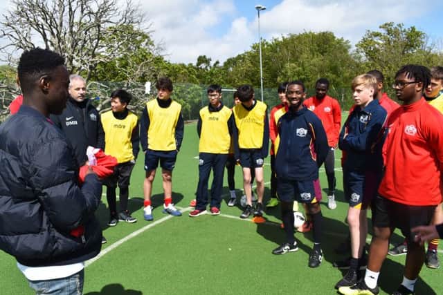 Arvin Appiah addresses young footballers at Buckswood School