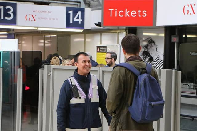 Customer Service Host Antonio Tapia welcomes a passenger at the Gatwick Express portal at London Victoria