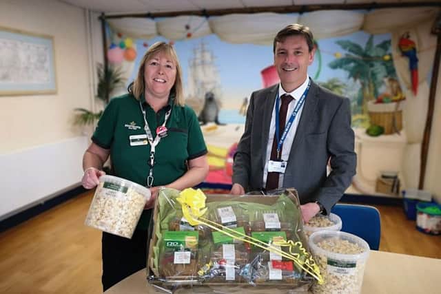 Dave Ayers, head teacher at River Beach Primary School, accepts the hamper for year-six pupils from Alison Whitburn, Morrisons Littlehampton community champion